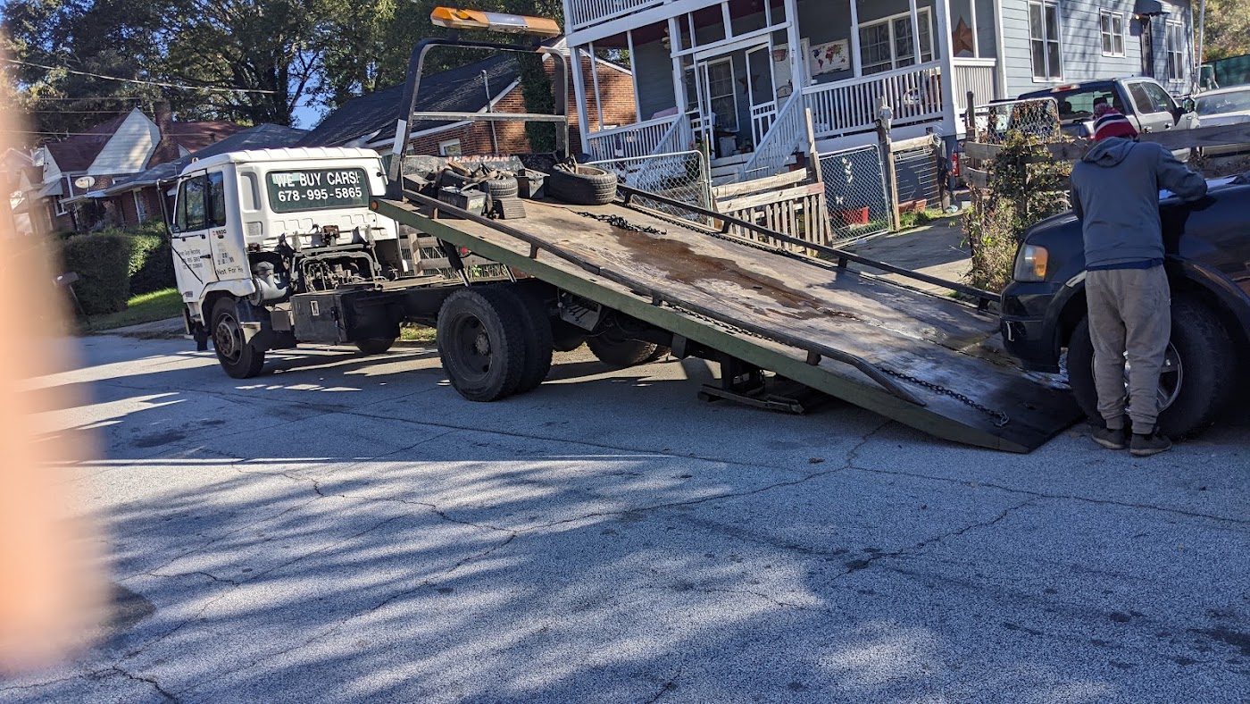 Green Guys loading a car
